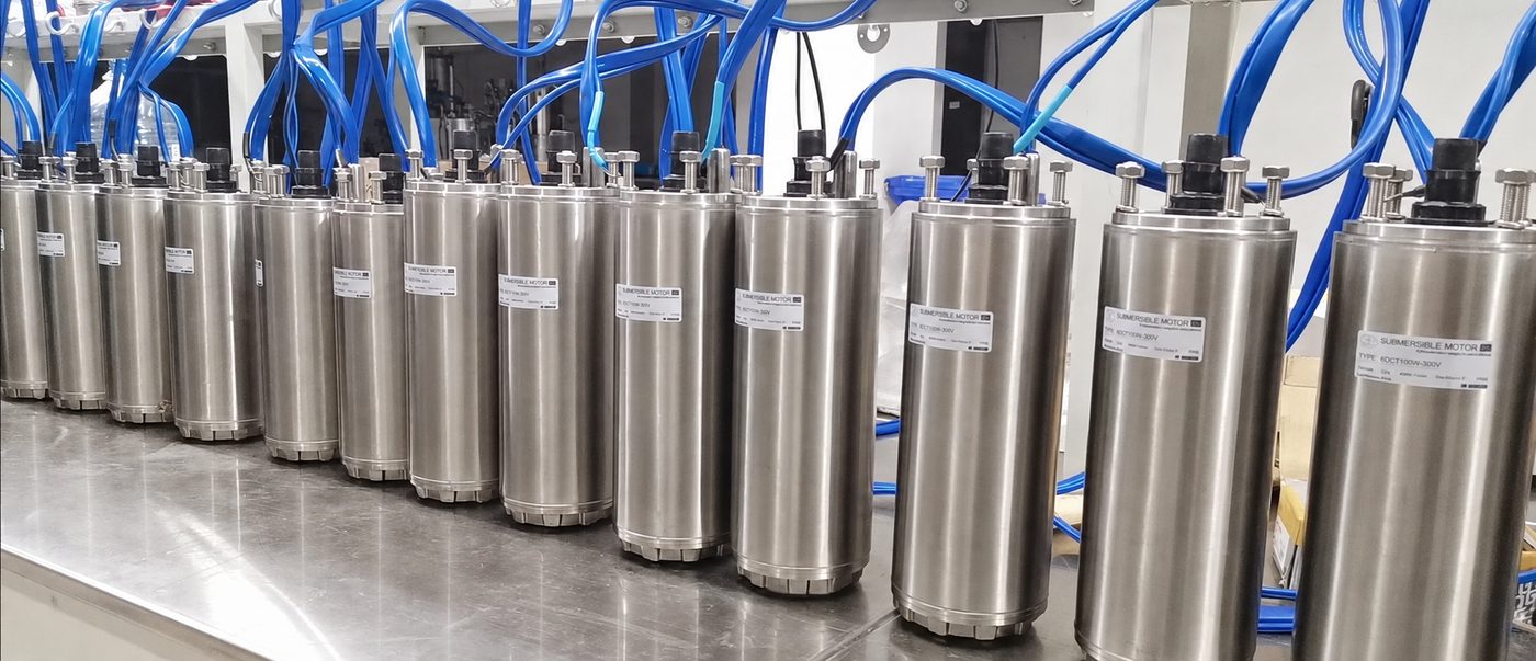 Row of 6-inch stainless steel DC submersible pump motors on a test bench